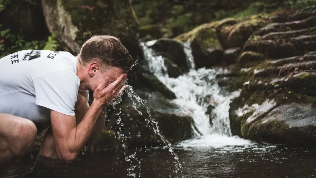 Man Splashing water to wake himself up